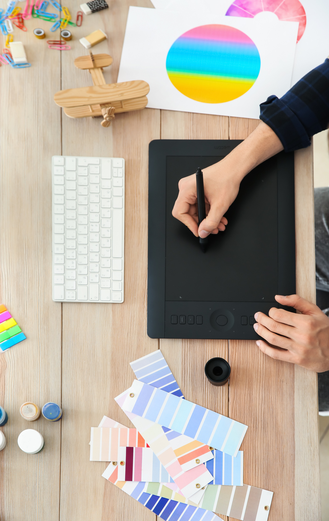 Young Designer with Graphic Tablet Working at Table